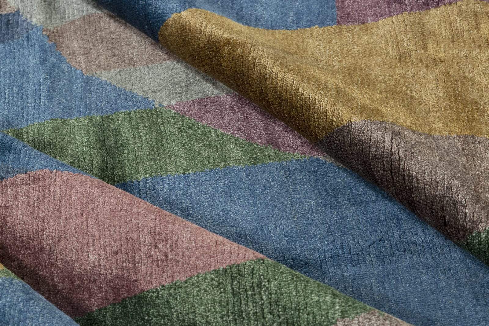 Detail shot of Gilded Cabernet, a hand knotted rug by Tufenkian Artisan Carpets