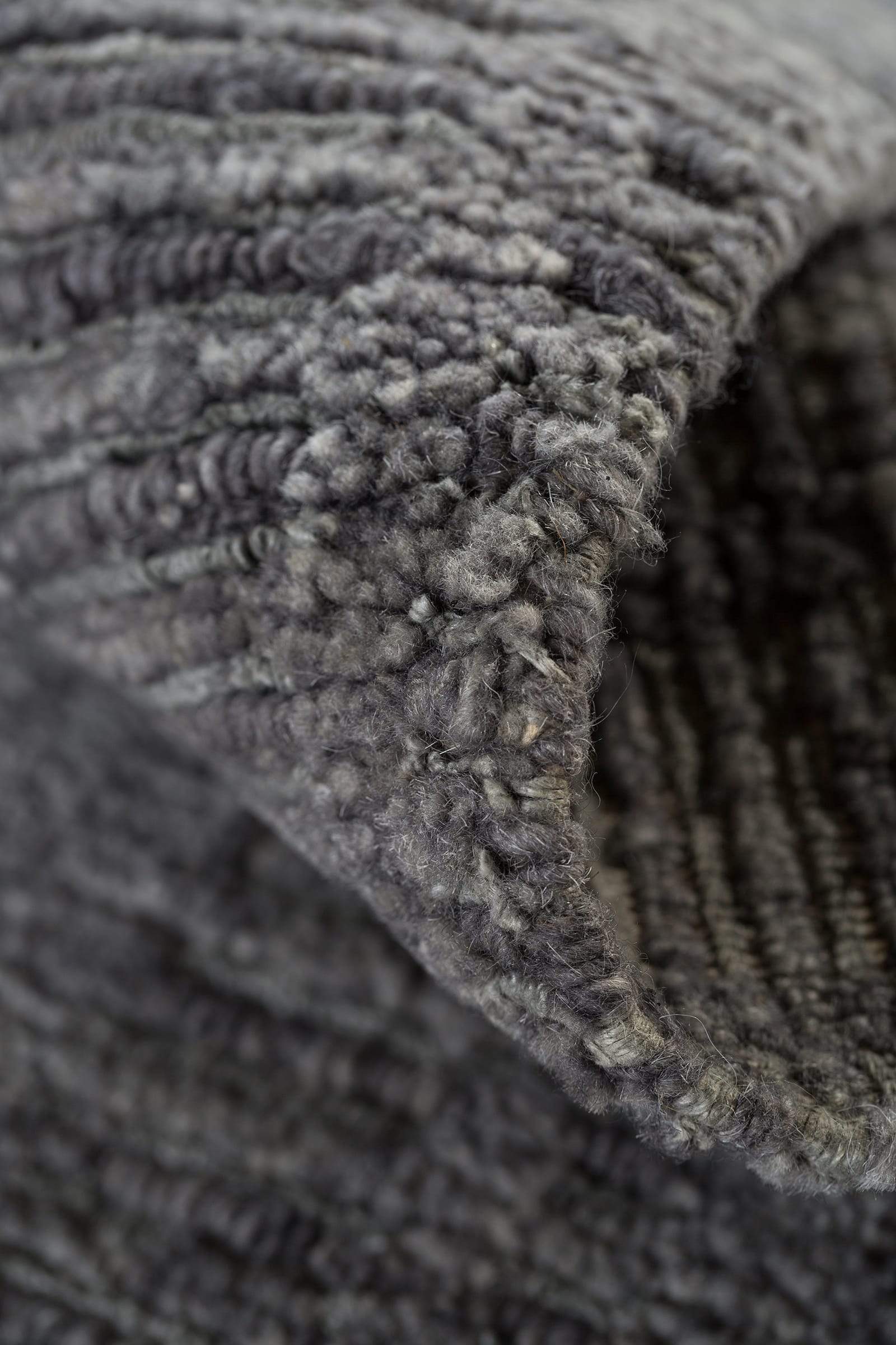 Detail shot of Rays II Light Charcoal, a hand knotted rug designed by Tufenkian Artisan Carpets. room-image